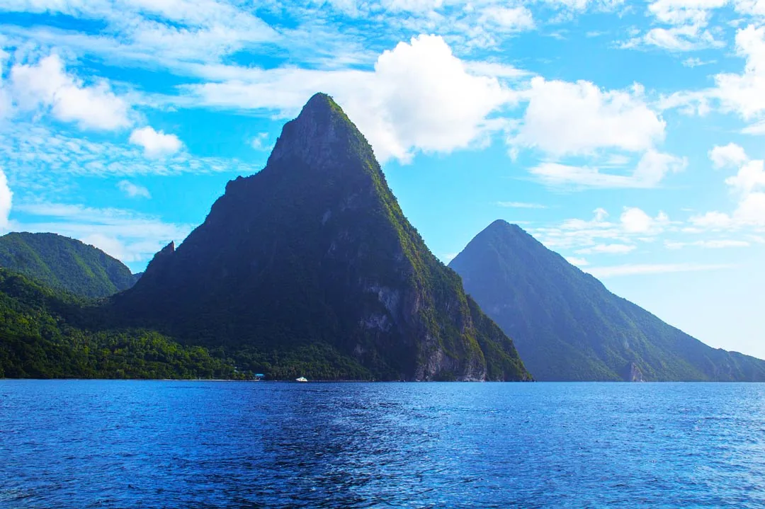 The Caribbean, pitons, mountains tower over the ocean.